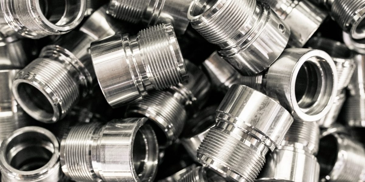 A pile of metal parts, CNC machine blanks. Pile of many CNC turning engineering parts